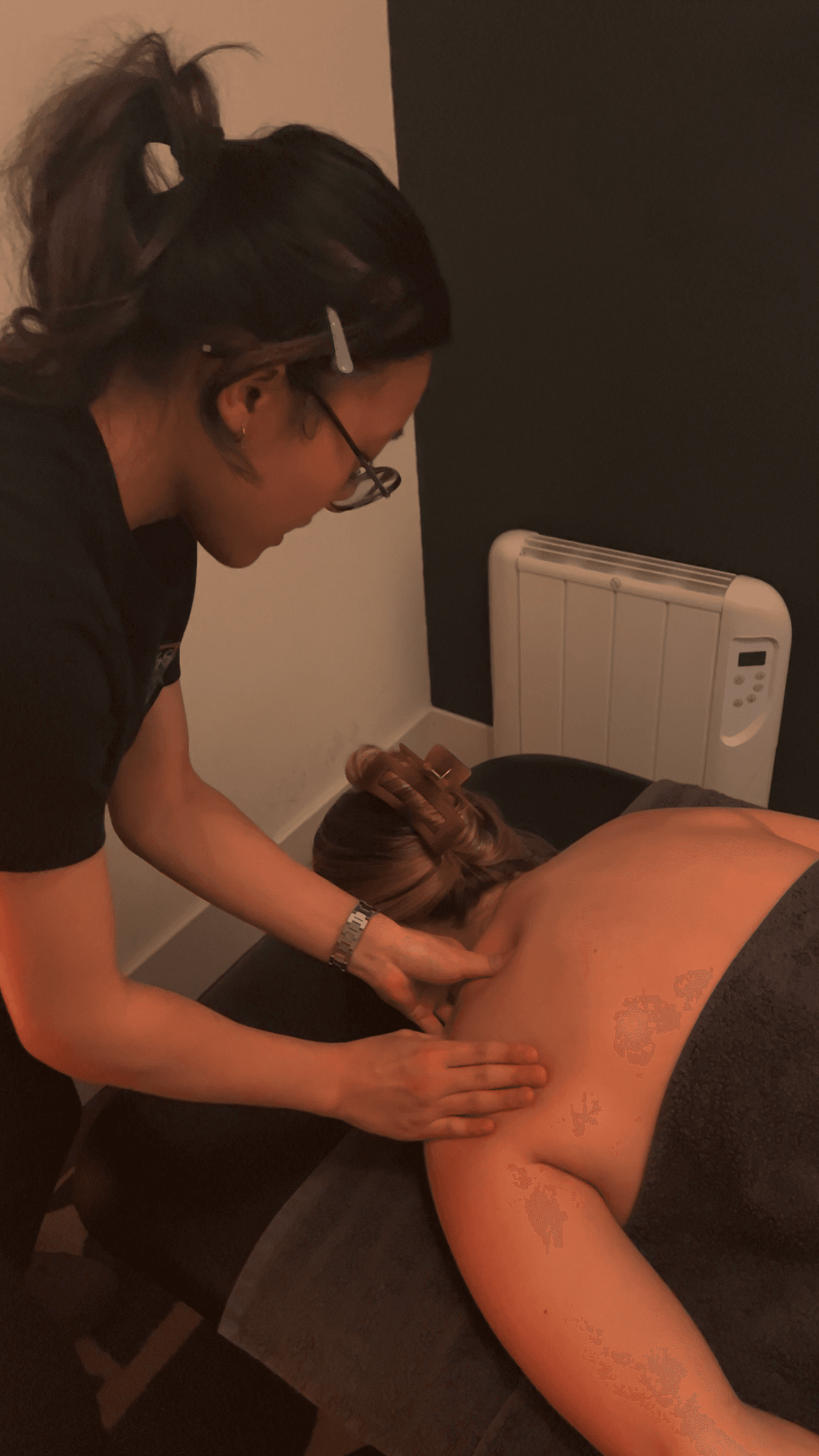 Massage therapist Chloe treating a client at Chiropractor Norwich